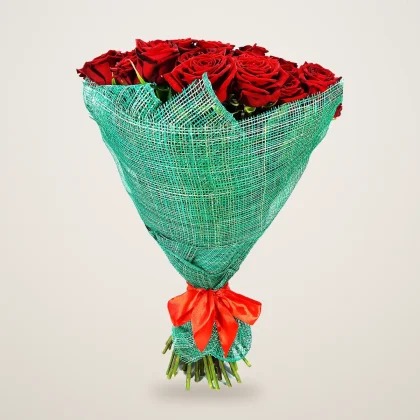 Red roses in green mesh wrap with an orange ribbon