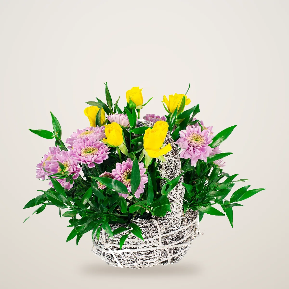 Yellow tulip basket with pink chrysanthemums in a white twig basket