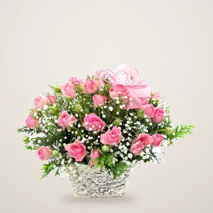 Pink rose and gypsophila basket in a rustic white woven basket