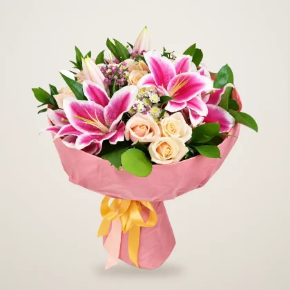 Lily and rose bouquet with pink lilies and white roses in pink wrap