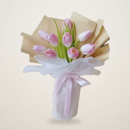 Pink tulip bouquet of soft pink tulips in cream wrap with a white ribbon