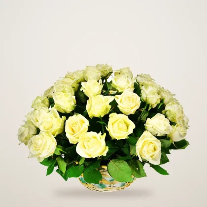 White rose basket with cream and white roses in a woven basket